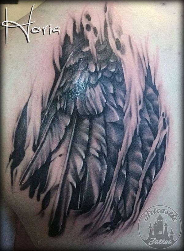 ArtCastleTattoo Tattoo ArtiestPrive Horia Realistic torn flesh tattoo with a realistic wing and feathers black n grey Black n Grey